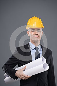Smart confident architect holding blueprints
