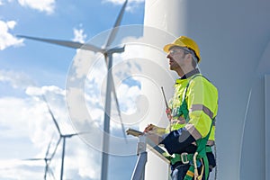 Smart confident engineer male Wind Turbines service team standing looking sky forward for the future of clean energy concept