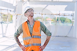 Smart construction engineer worker architect. Builder foreman work in construction site standing checking building workplace