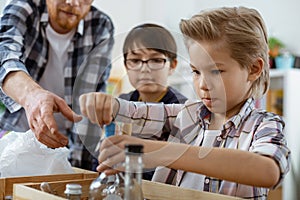 Smart diligent teacher explaining his pupils principles