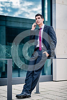 Smart dressed man talking in phone