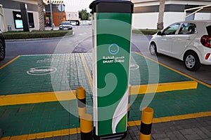 Smart Dubai car charging stations in parking lot. Charging modern electric cars new energy vehicles, NEV on the street station.