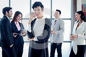 Smart and elegant smiling business woman lady boss with black short hair confidential standing and holding coffee paper cup at the