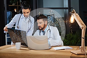 Smart experienced man studying an X ray photo