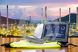 Smart factory - Rugged computers tablet in front of oil refinery photo