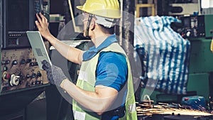 Smart factory worker using machine in factory workshop