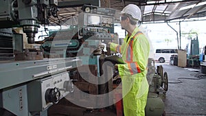 Smart factory worker using machine in factory workshop