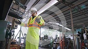 Smart factory worker using machine in factory workshop