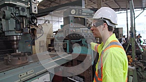 Smart factory worker using machine in factory workshop