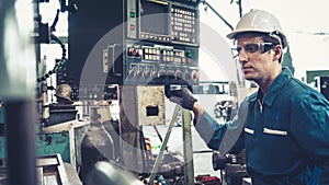 Smart factory worker using machine in factory workshop