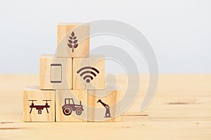 Smart farm or agriculture futuristic technology concept, wooden cube icon connect, icon including wireless wifi, ai or artificial photo