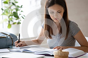 Smart female student studying handwriting at home
