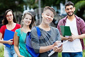 Smart german male student with group of other students