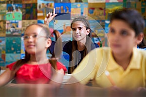 Smart Girl Raising Hand And Asking Question At School