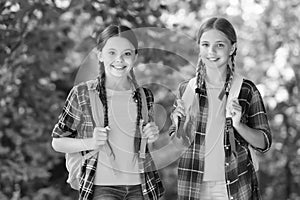 Smart girls. childhood hapiness. two sisters in school uniform outdoor. ready for holidays. happy teen kids carry