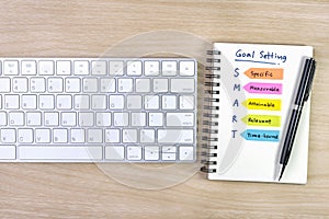 Smart goals setting written on the notebook with pen