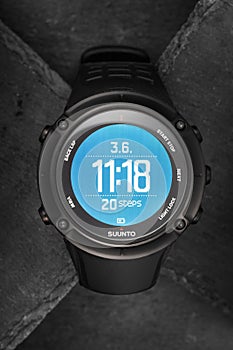 Smart GPS Suunto watch for sports and adventure on slate background. Smartwatch with digital screen. Electronic wireless gadget