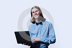 Smart guy student using laptop looking at camera, white background