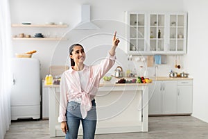 Smart Home Concept. Millennial Woman Pointing Finger Up
