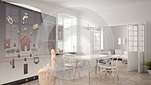 Smart home control concept, hand controlling digital interface from mobile app. Blurred background showing modern kitchen, archite