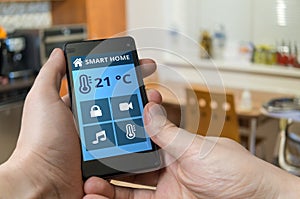 Smart home control concept. Man is adjusting temperature with smartphone