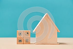 Smart home. Online services. Remote control from any device. Wooden house miniature and cubes with symbols. Copy space