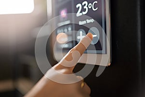 Smart home system, wall and woman hands with digital app monitor for thermostat heating, temperature control or house