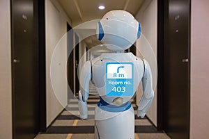 Smart hotel in hospitality industry 4.0 technology concept, robot butler robot assistant use for greet arriving guests, deliver photo