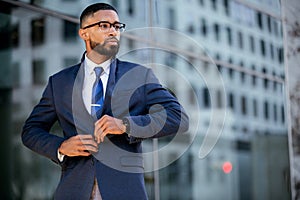 Smart intelligent successful modern african american business man in stylish suit and glasses, lifestyle candid portrait