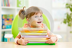 Smart kid girl preschooler with books