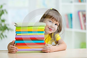 Smart kid girl preschooler with books