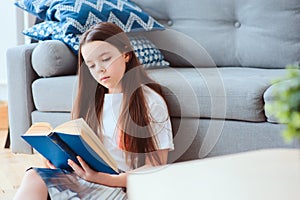 smart kid girl reading interesting book