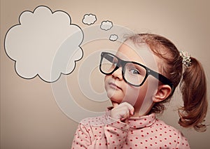 Smart kid in glasses thinking with speech bubble above. Vintage