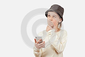 Smart kid holding a mobile phone. Technology, lifestyle and people concept. Cute boy using a smart phone over white background