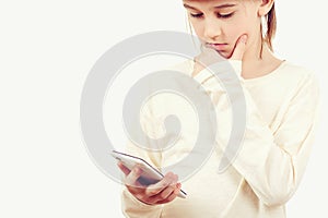 Smart kid holding a mobile phone. Technology, lifestyle and people concept. Cute boy using a smart phone over white background