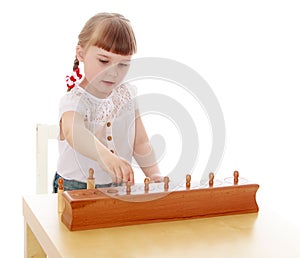 Smart little girl in a Montessori kindergarten