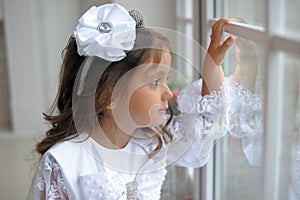 Smart little girl in white dress