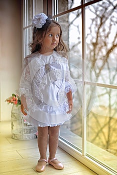 Smart little girl in white dress