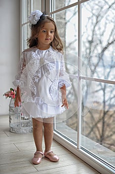 Smart little girl in white dress
