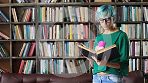 Smart looking female student reading in library