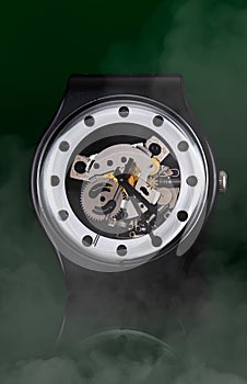 Smart looking watch with smoke and green surroundings