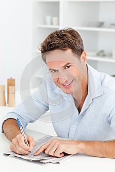 Smart man doing a cryptic crossword photo