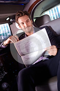 Smart man reading news in limousine