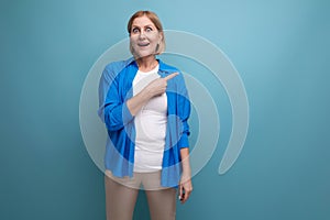 smart mature woman thinking brilliant idea on blue background with copyspace