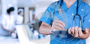 Smart medical doctor writing nformation patient medical on a clipboard at the hospital