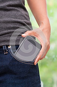 Smart mobile phone in jeans pocket