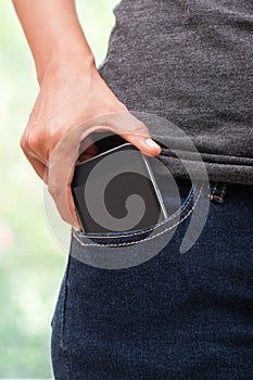 Smart mobile phone in jeans pocket