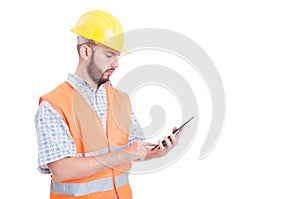 Smart and modern builder or engineer using tablet