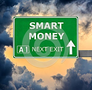 SMART MONEY road sign against clear blue sky