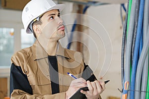 smart pensive builder thinking about something indoors